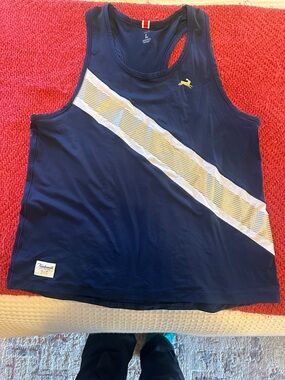Tracksmith women’s Navy running singlet with Gold Diagonal Stripe
